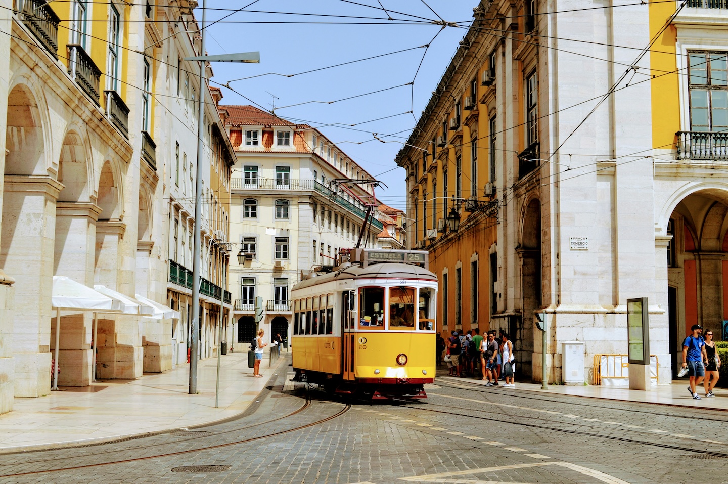 A yellow tram on a sunny street in Portugal